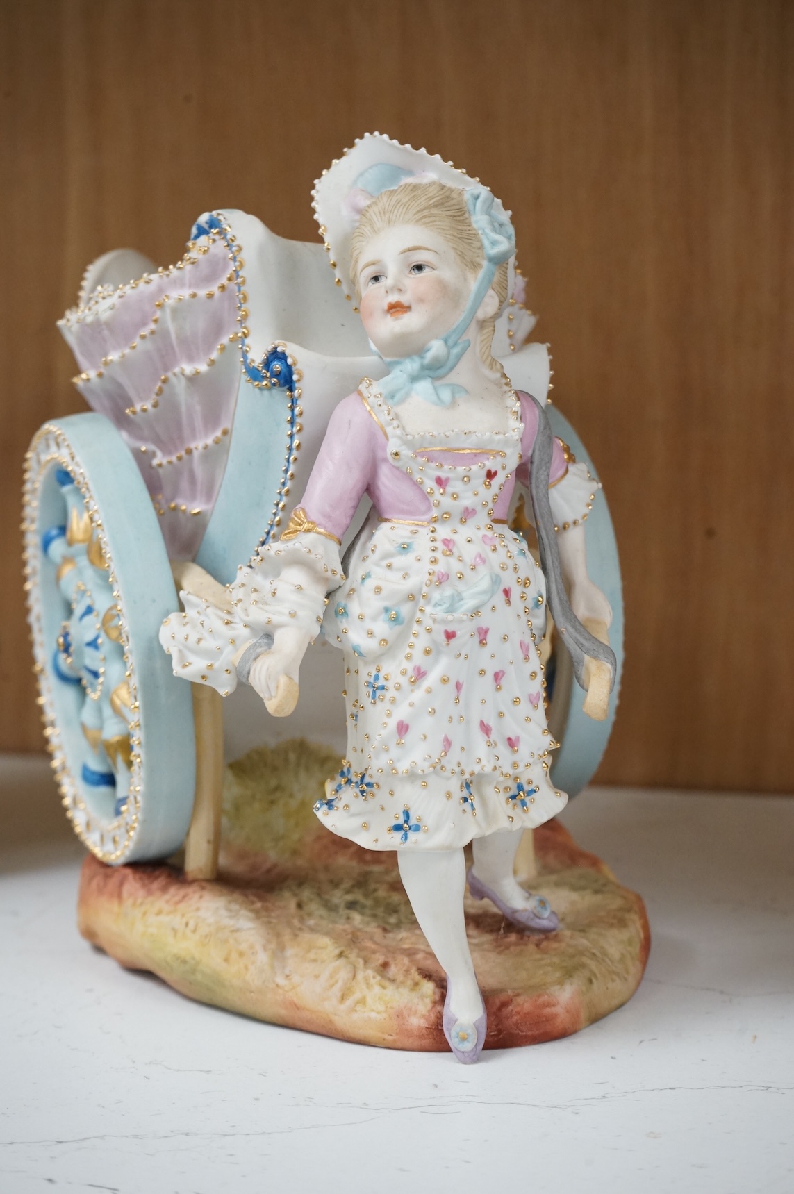A pair of French coloured biscuit porcelain carriage group centre pieces, 21cm wide